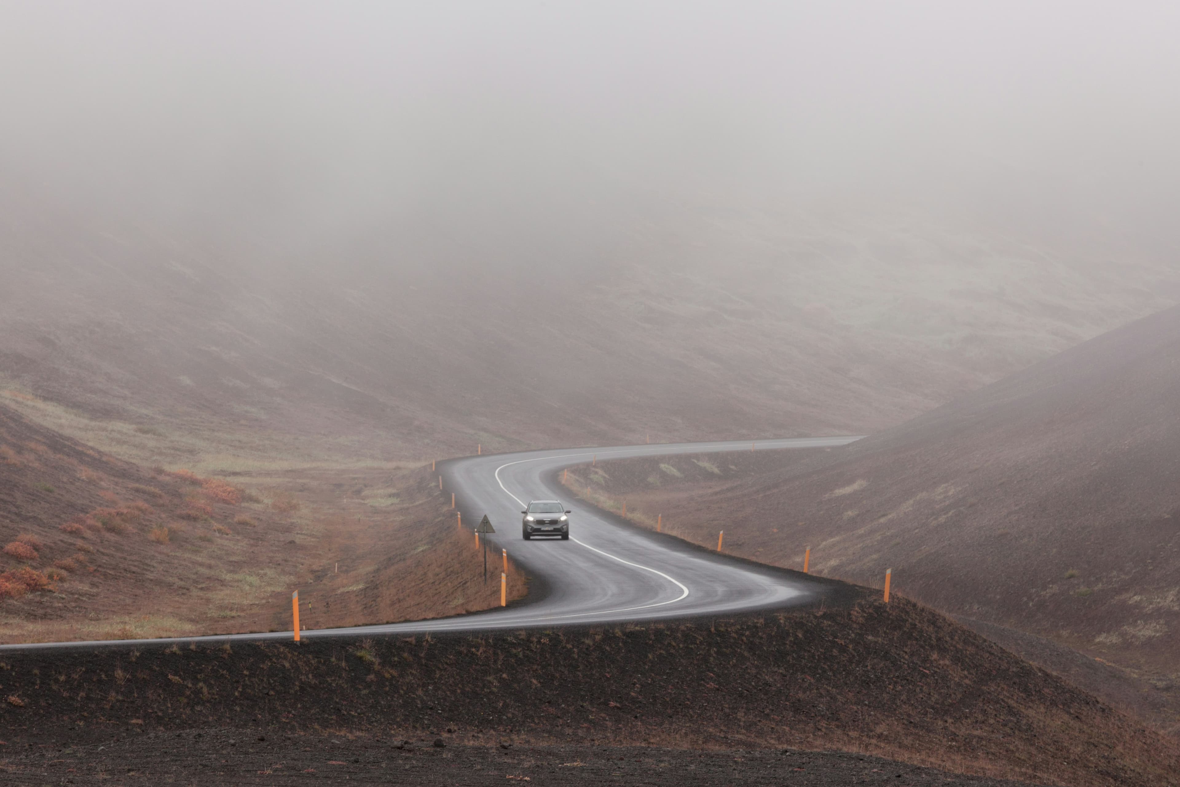 Zenvo vehicle on a winding mountain road in fog
